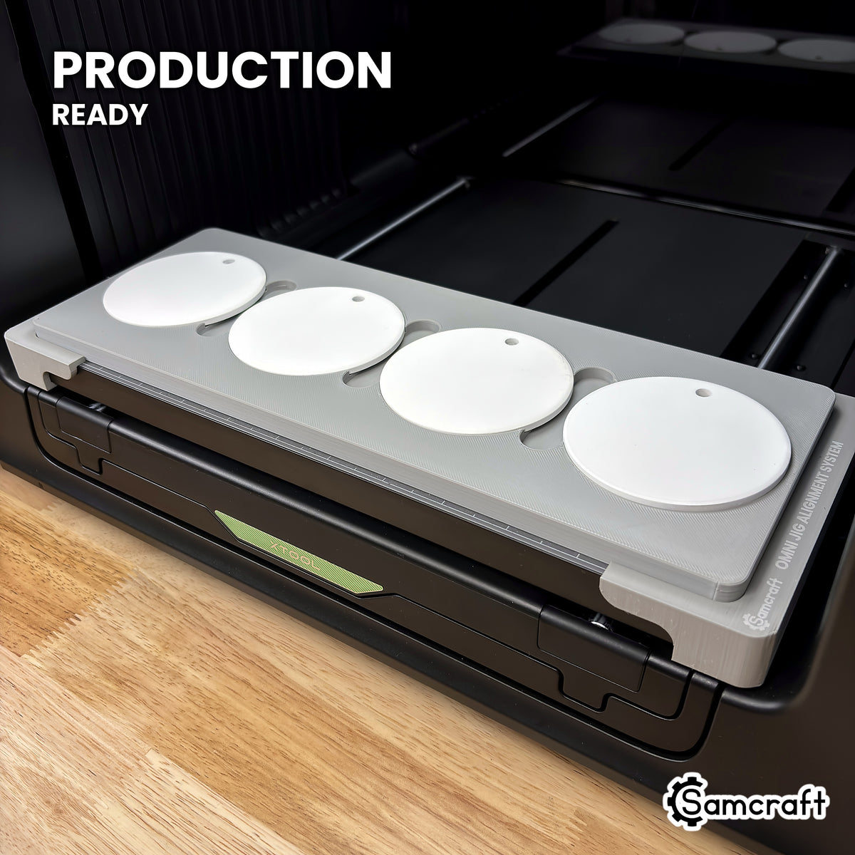 Samcraft round ceramic ornament jig holding four white ceramic ornaments on the xTool Omni UV printer bed, set up for production runs.