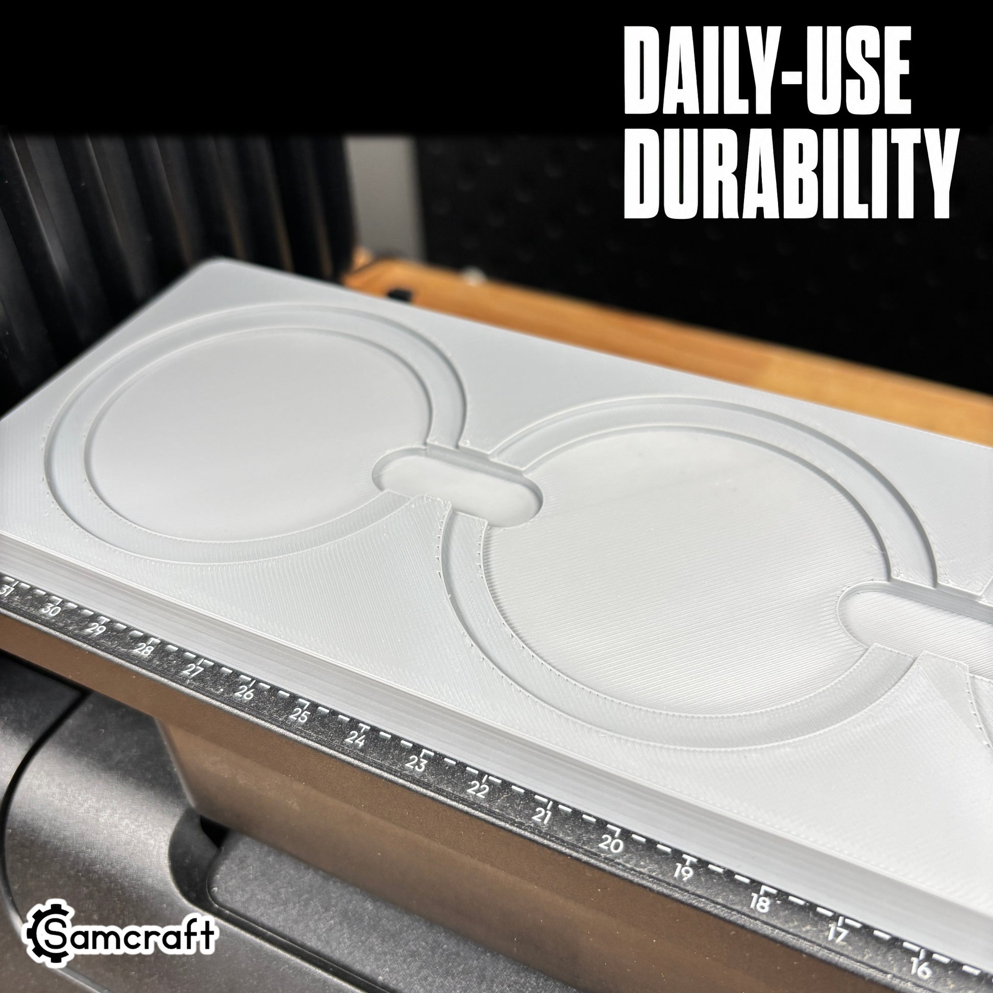 Round Patch Jig for the eufyMake E1 — close-up of round black leather patches with white stitched borders resting in the circular pockets of the gray one-piece tray with built-in alignment ruler, built for daily-use durability.