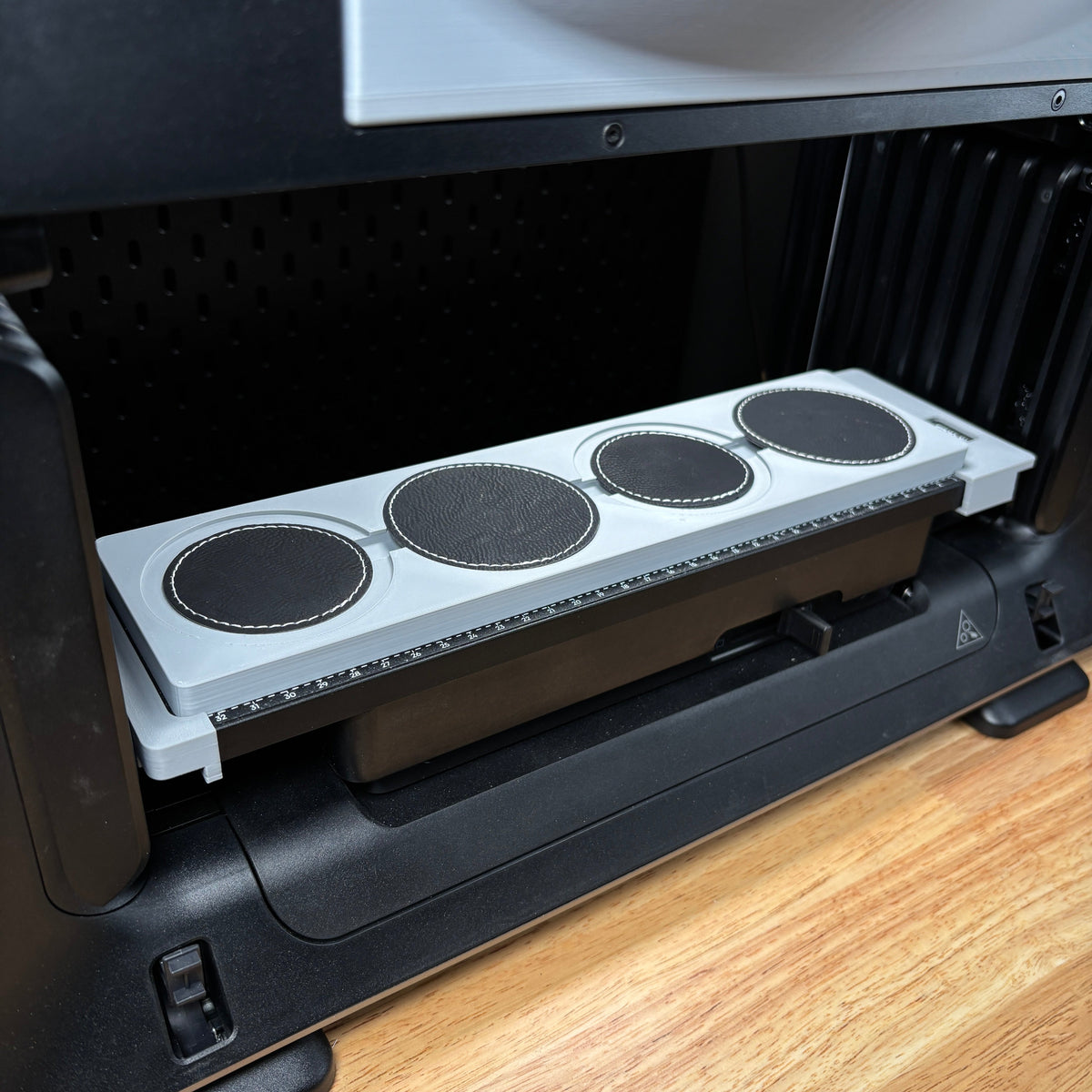 Samcraft round patch jig on the eufyMake E1 print bed, holding four round black patches in circular recesses.