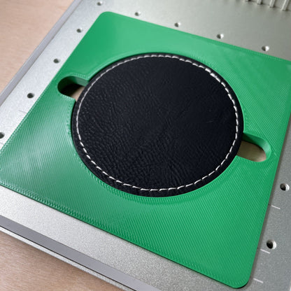 Samcraft round patch jig in an xTool F1 laser bed, holding a large black leatherette round patch.