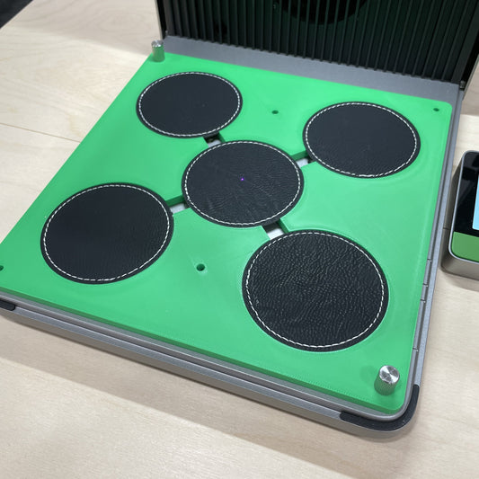 Samcraft green round patch jig in an xTool F1 Ultra laser bed, holding four round dark leatherette patches.