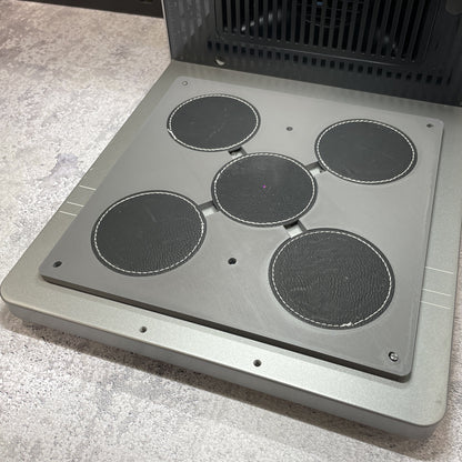 Samcraft round patch jig on the xTool F2 Ultra bed, holding round leatherette patches in two sizes.