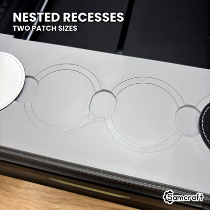 Close-up of the nested recesses in the Samcraft xTool Omni round patch jig, the larger patch in the outer step and the smaller one in the inner.