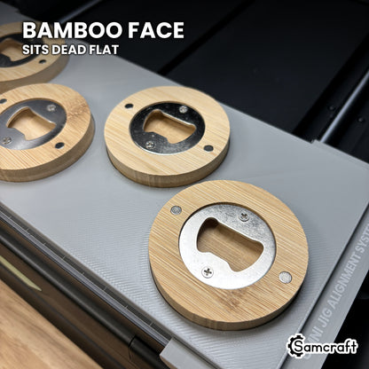 Close-up of a bamboo bottle opener sitting dead flat in the Samcraft xTool Omni jig for an even print across the face.