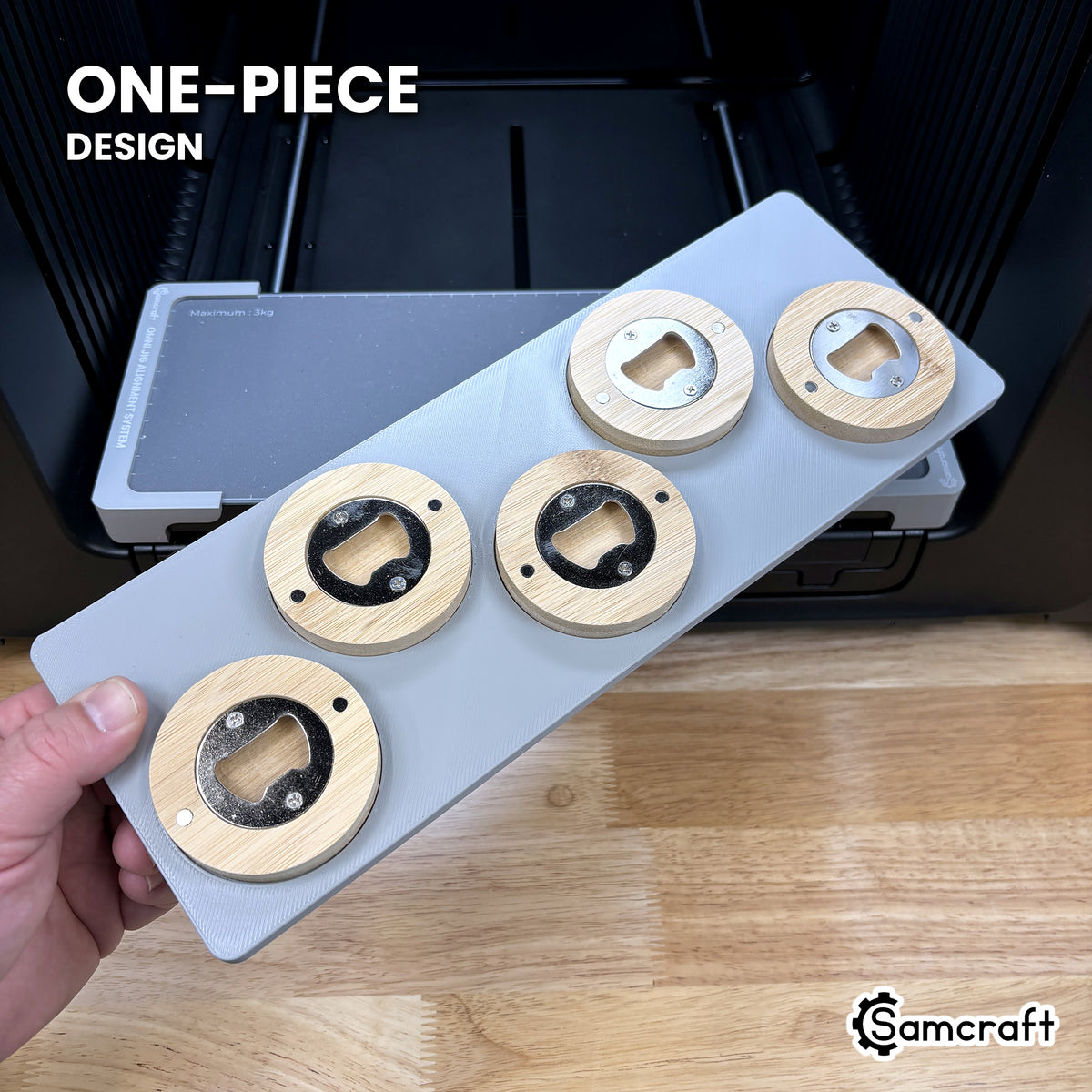 Hand holding the one-piece Samcraft round wooden bottle opener jig for the xTool Omni, five openers seated in a single molded tray.