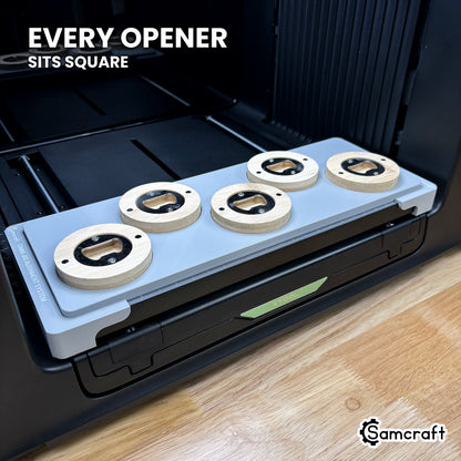 Every round wooden opener seated square in its own pocket across the Samcraft xTool Omni jig, for consistent print placement.