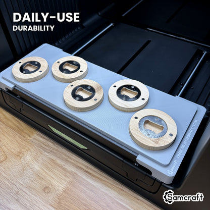 Samcraft round wooden opener jig in high-temperature rated plastic holding five bamboo openers on the xTool Omni bed, built for daily-use durability.