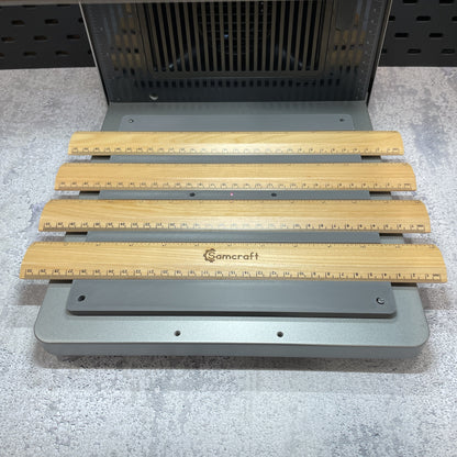 Samcraft ruler jig on the xTool F2 Ultra bed, holding wooden rulers.