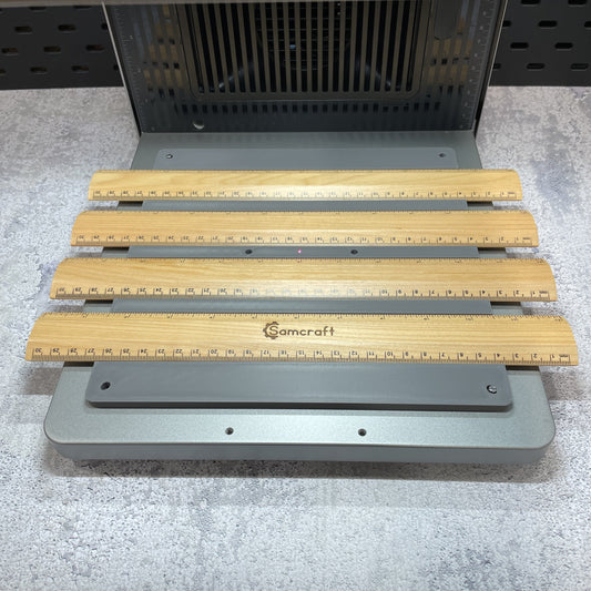 Samcraft ruler jig on the xTool F2 Ultra bed, holding wooden rulers.