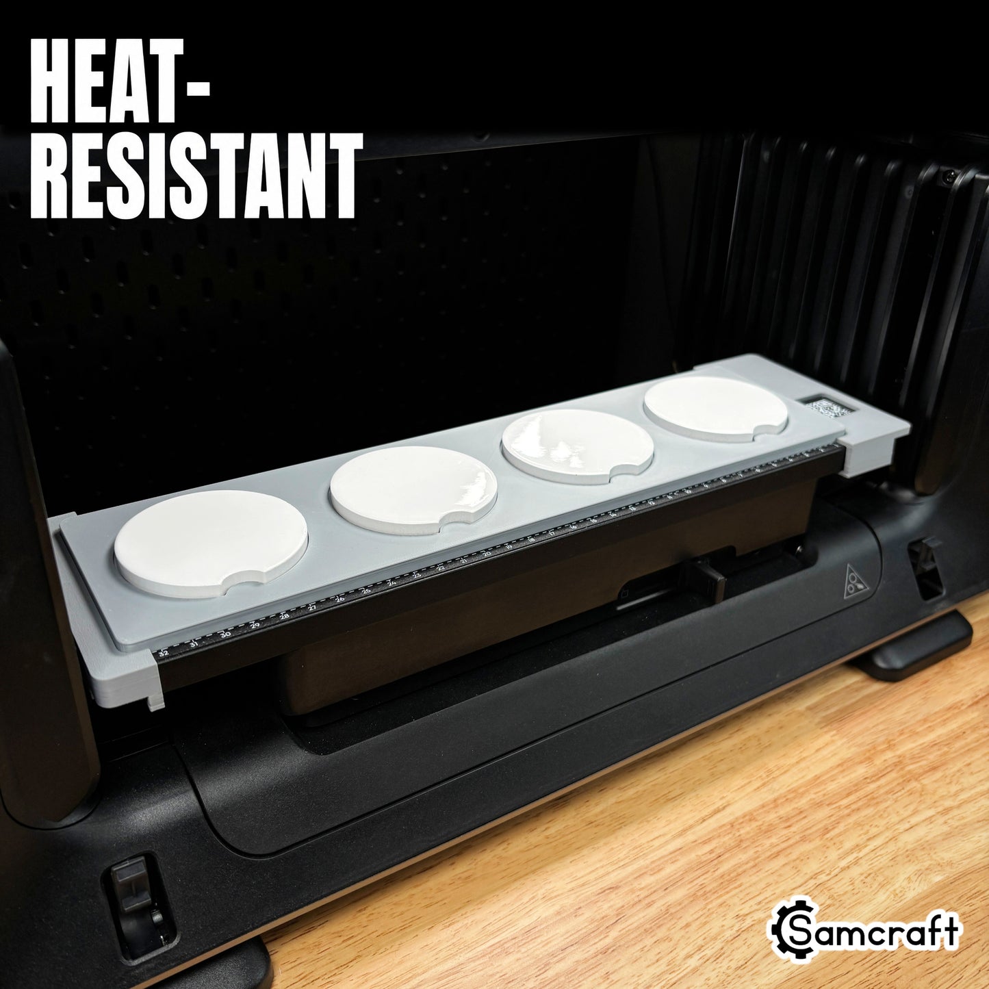 Samcraft heat-resistant car coaster jig from the left, holding four round coasters on a eufyMake UV printer bed