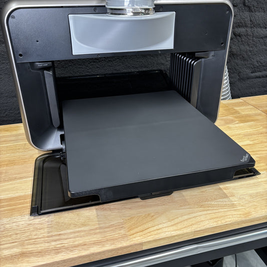 Samcraft FatMat fitted to the print bed of a eufyMake E1 UV printer, the black silicone mat filling the tray.