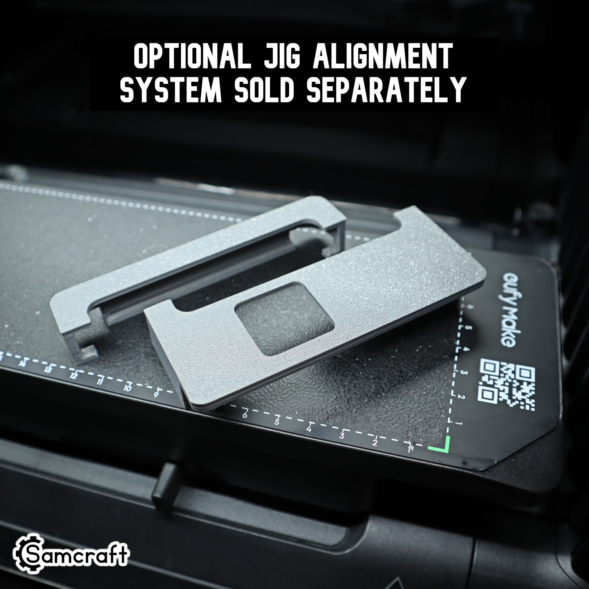 Close-up of Samcraft's optional jig alignment system, two gray 3D-printed alignment pieces sitting on a eufyMake UV printer bed