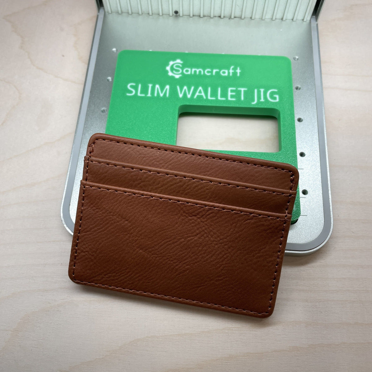 Samcraft slim wallet jig shown with a tan leather card holder resting against it, the wallet size marked on the jig.