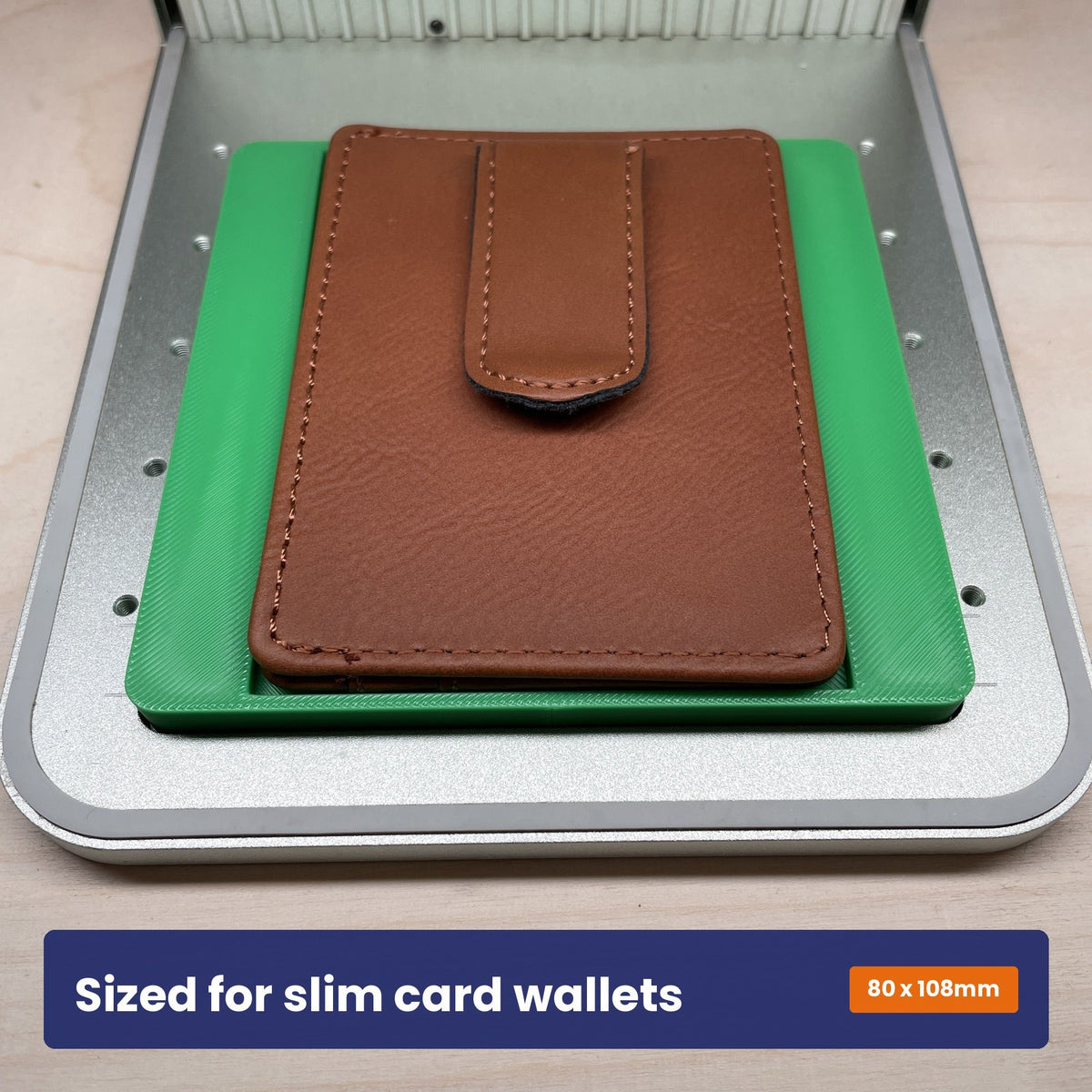 Slim wallet jig holding a brown leather card holder upright in the xTool F1 bed.