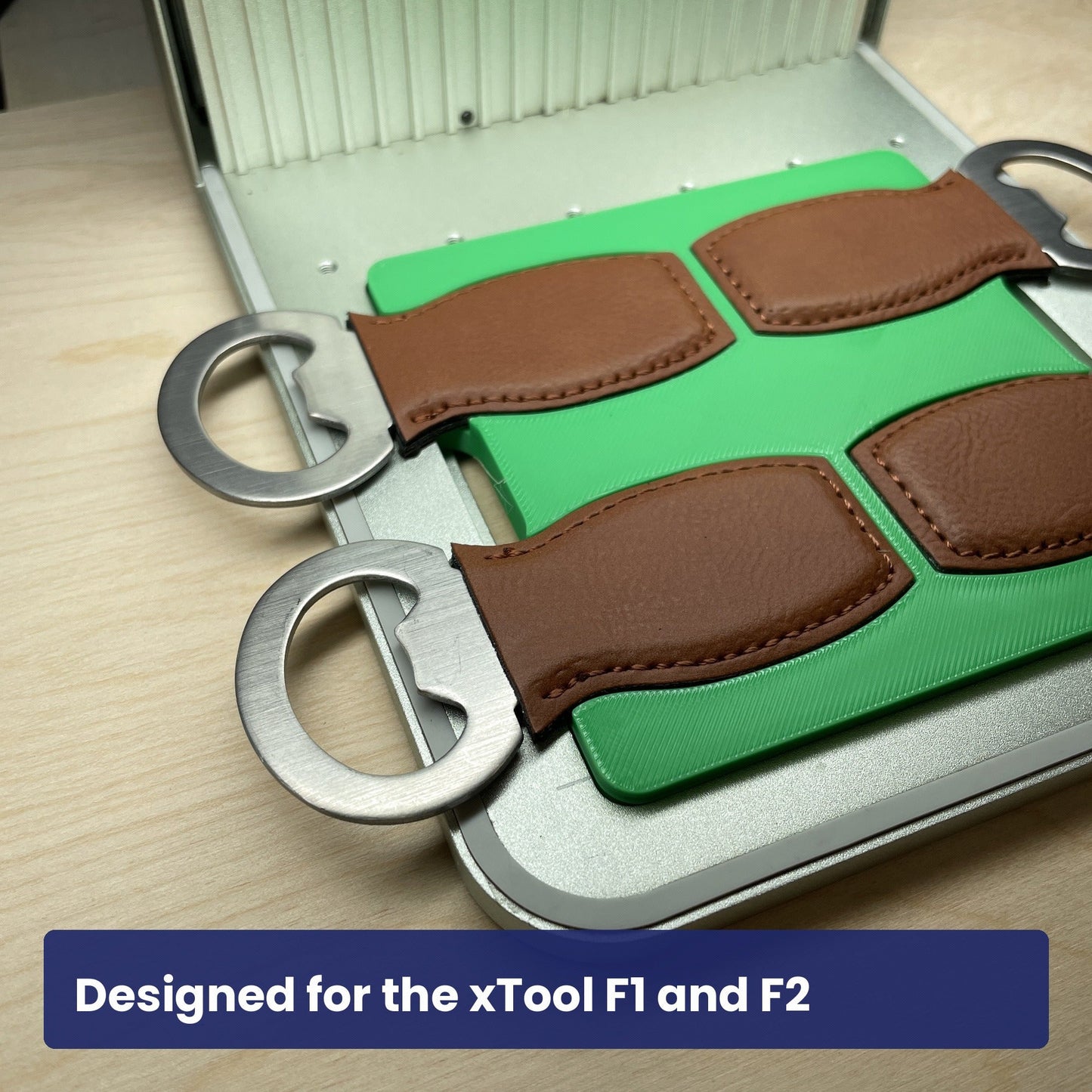 Samcraft small bottle opener jig seated in the xTool F1 base plate with openers in place.