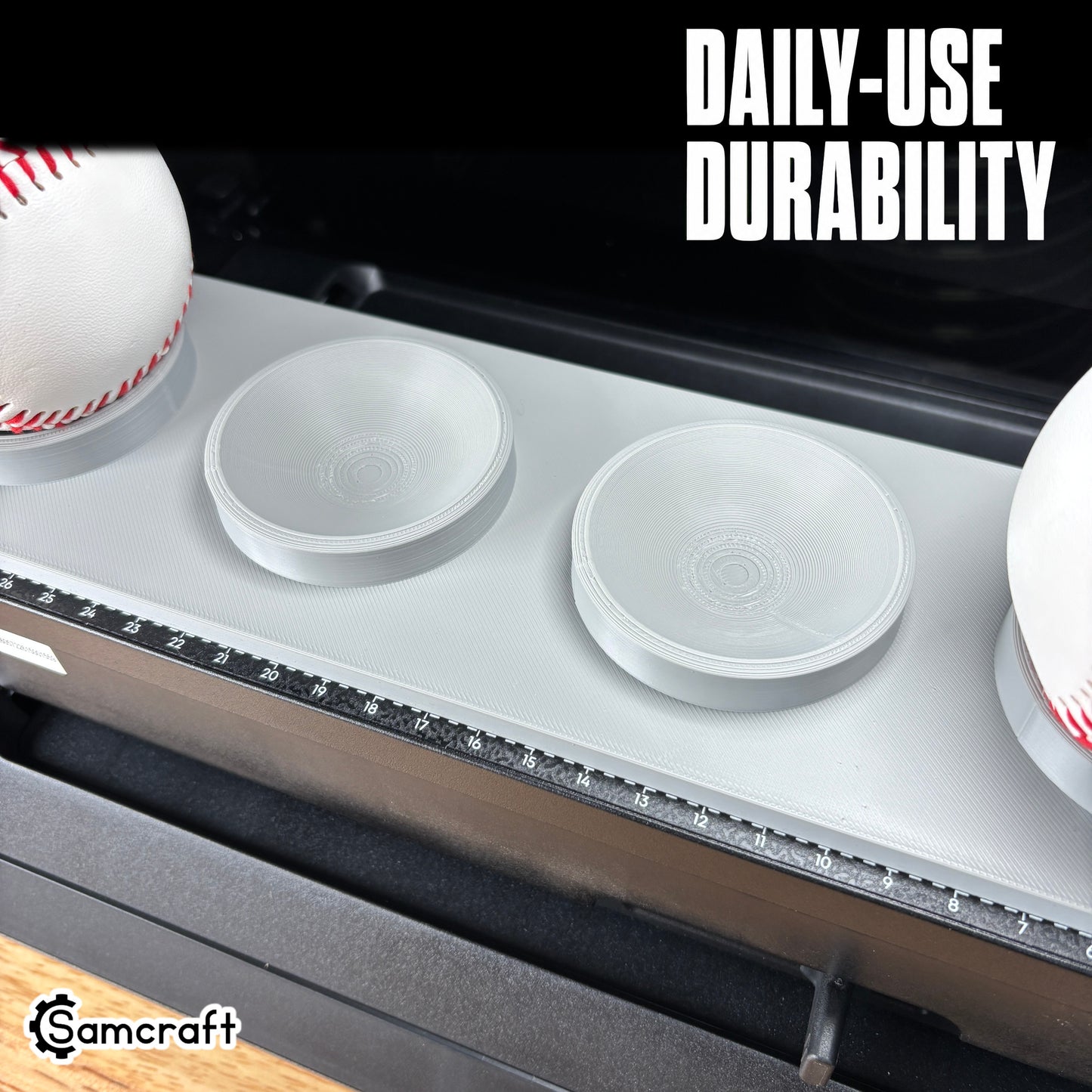 Sports Ball Jig for the eufyMake E1 — close-up of the gray 3D-printed tray with baseballs and empty ring holders on the printer bed with built-in alignment ruler, highlighting daily-use durability.