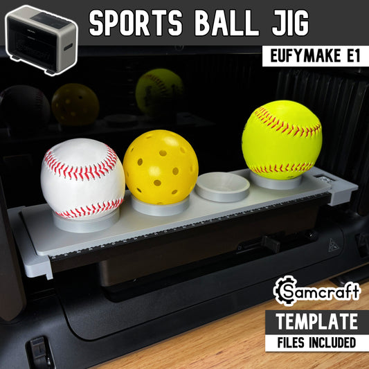 Sports Ball Jig for the eufyMake E1 — gray one-piece 3D-printed tray holding a baseball, pickleball, and softball in cupped ring holders on the printer bed with built-in alignment ruler, available in multiple sizes, template files included.