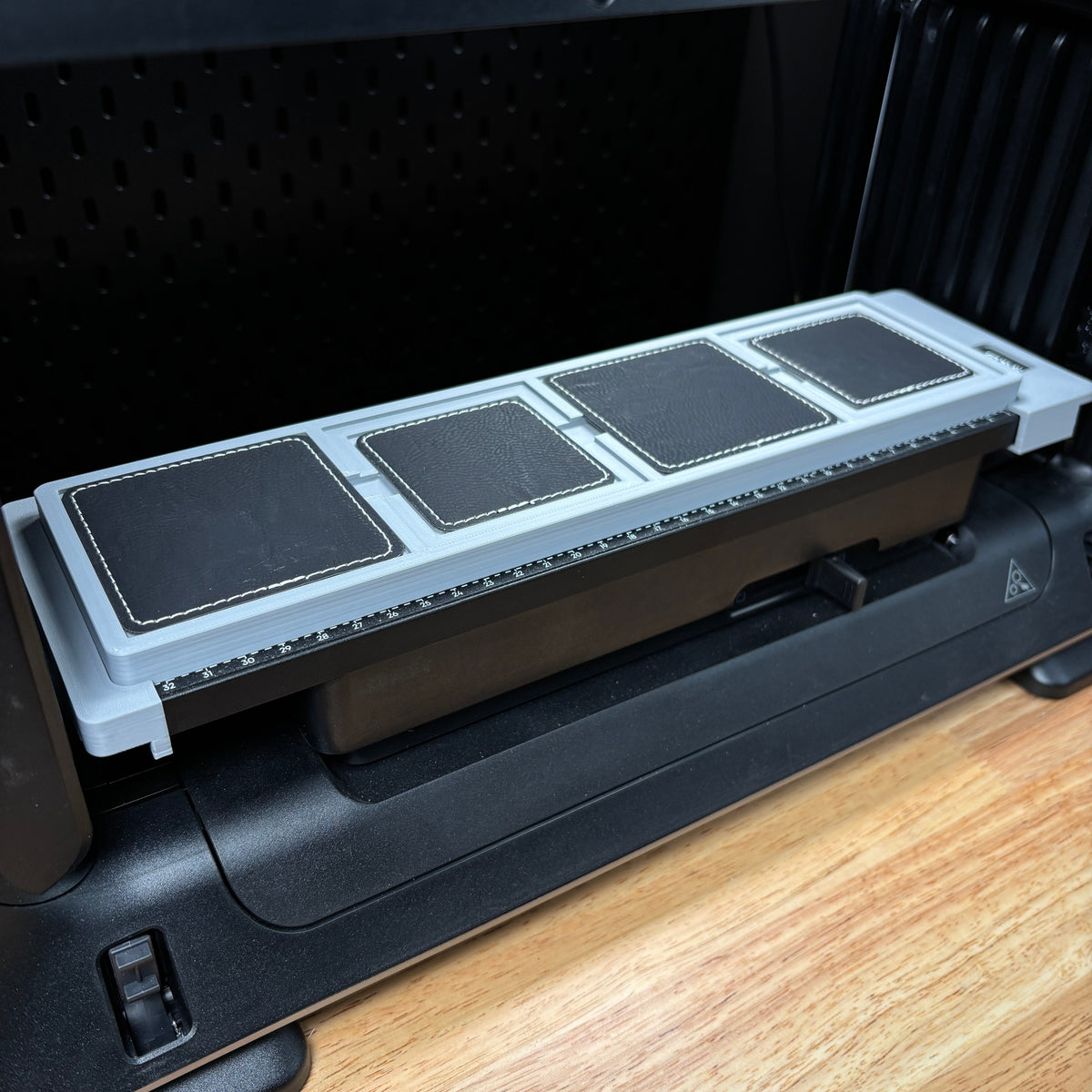 Samcraft square patch jig on the eufyMake E1 print bed, holding black square patches.
