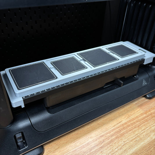 Samcraft square patch jig on the eufyMake E1 print bed, holding black square patches.