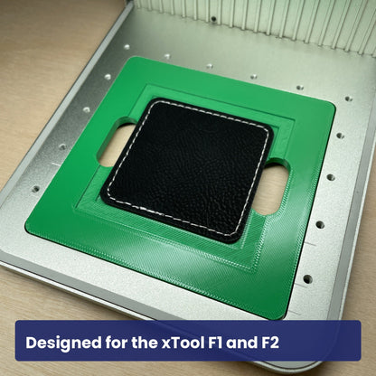 Green Samcraft square patch jig seated in the xTool F1 base plate with a leatherette patch in place.