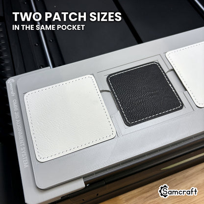 Two sizes of square leatherette patch shown side by side in the Samcraft xTool Omni jig, both seated from the same nested pocket.