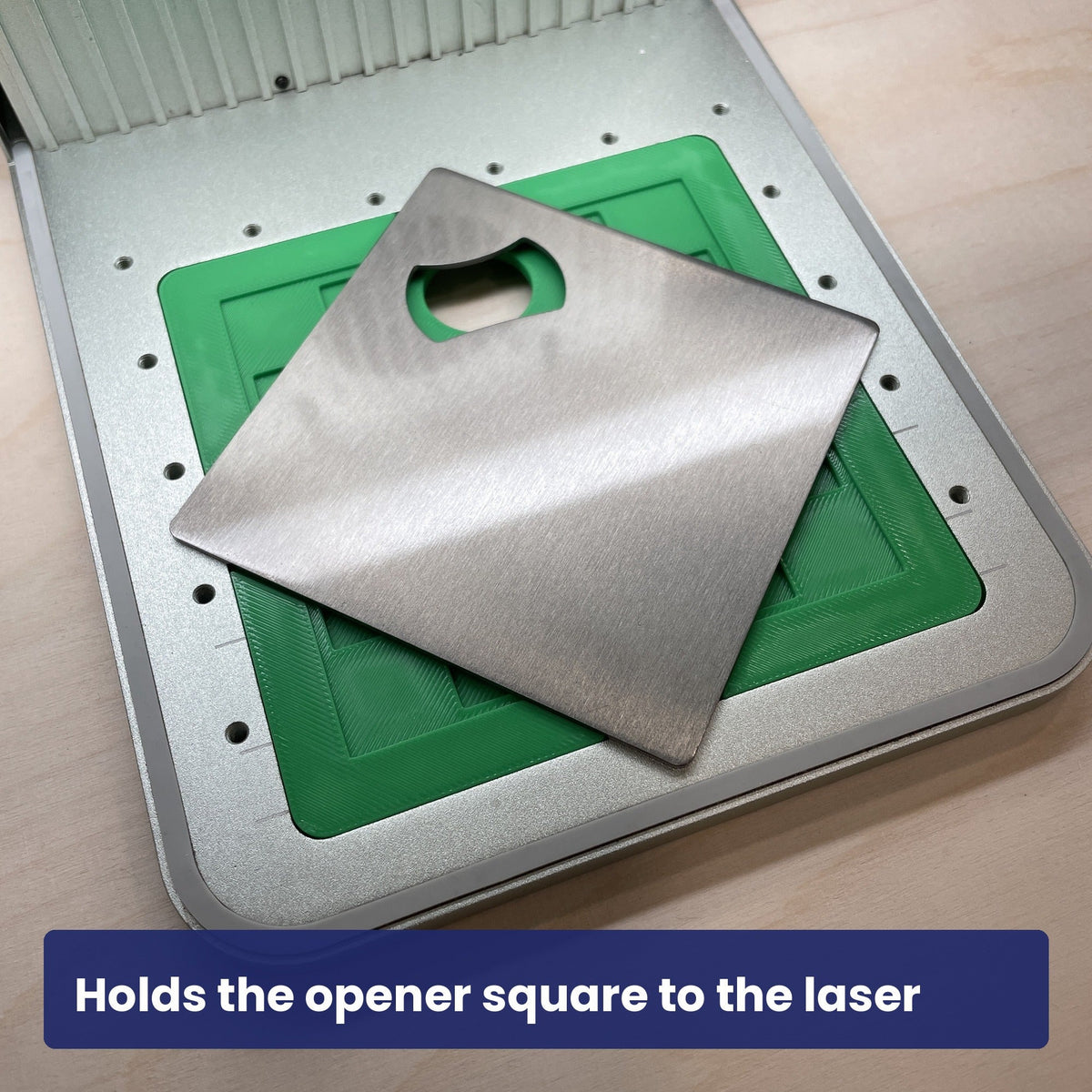 Stainless steel bottle opener held square in the Samcraft jig, ready to engrave.
