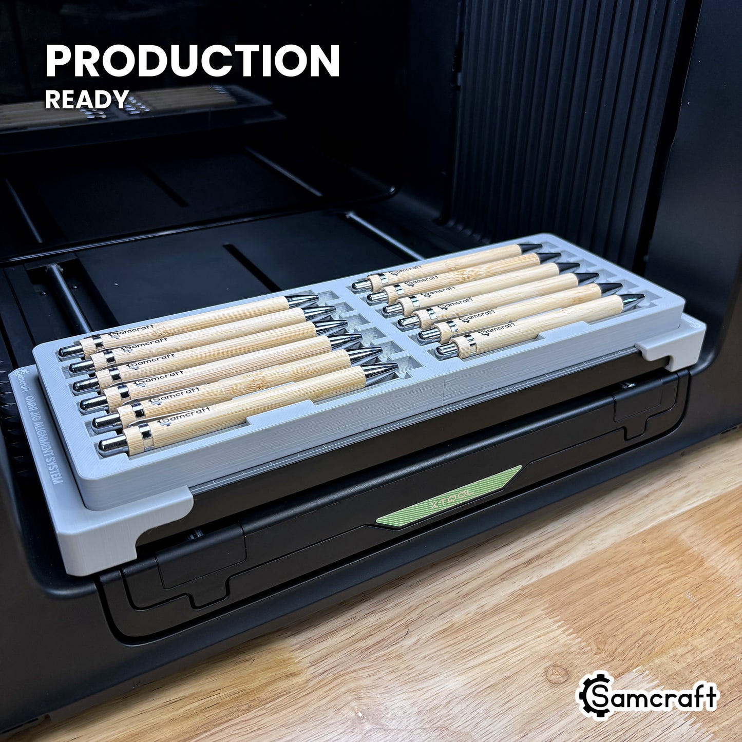 Samcraft 12 pen jig loaded with twelve pens on the xTool Omni UV printer bed, set up for production runs.