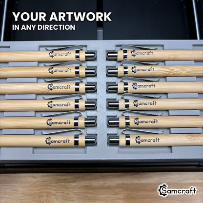 Two rows of pens loaded facing opposite directions in the Samcraft xTool Omni pen jig, artwork landing correctly either way.