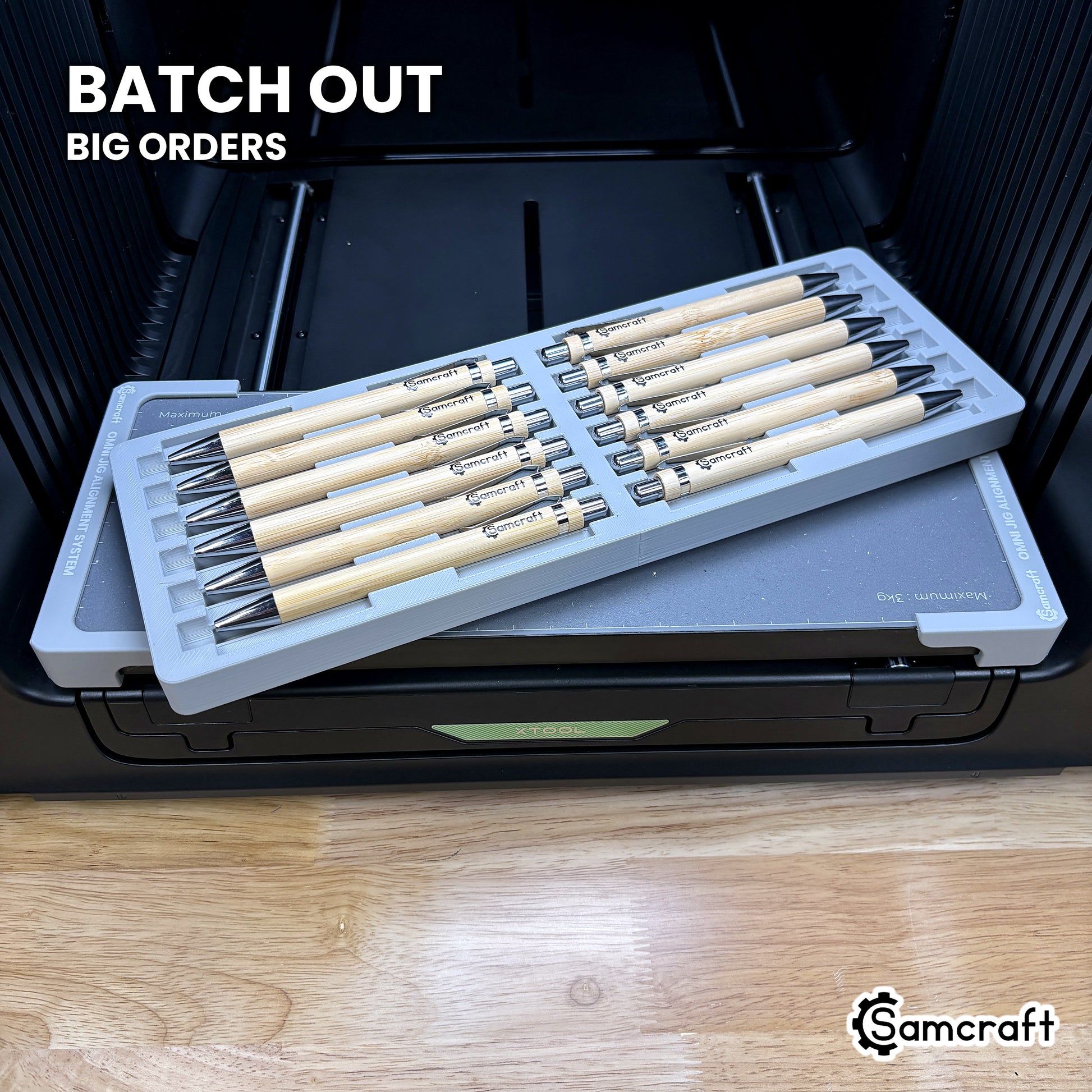 Samcraft xTool Omni 12 pen jig filled with twelve printed pens, ready for corporate gift and promotional batch orders.