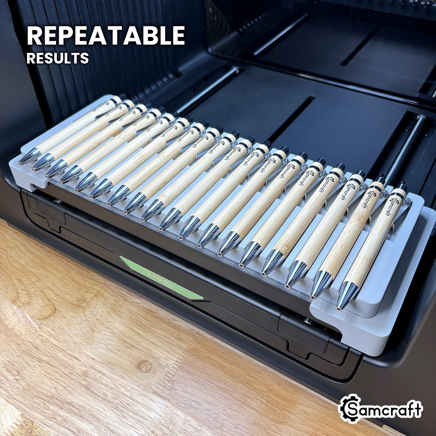 Angled view of the Samcraft 18 pen jig on the xTool Omni printer bed, loaded with bamboo pens for repeatable results.