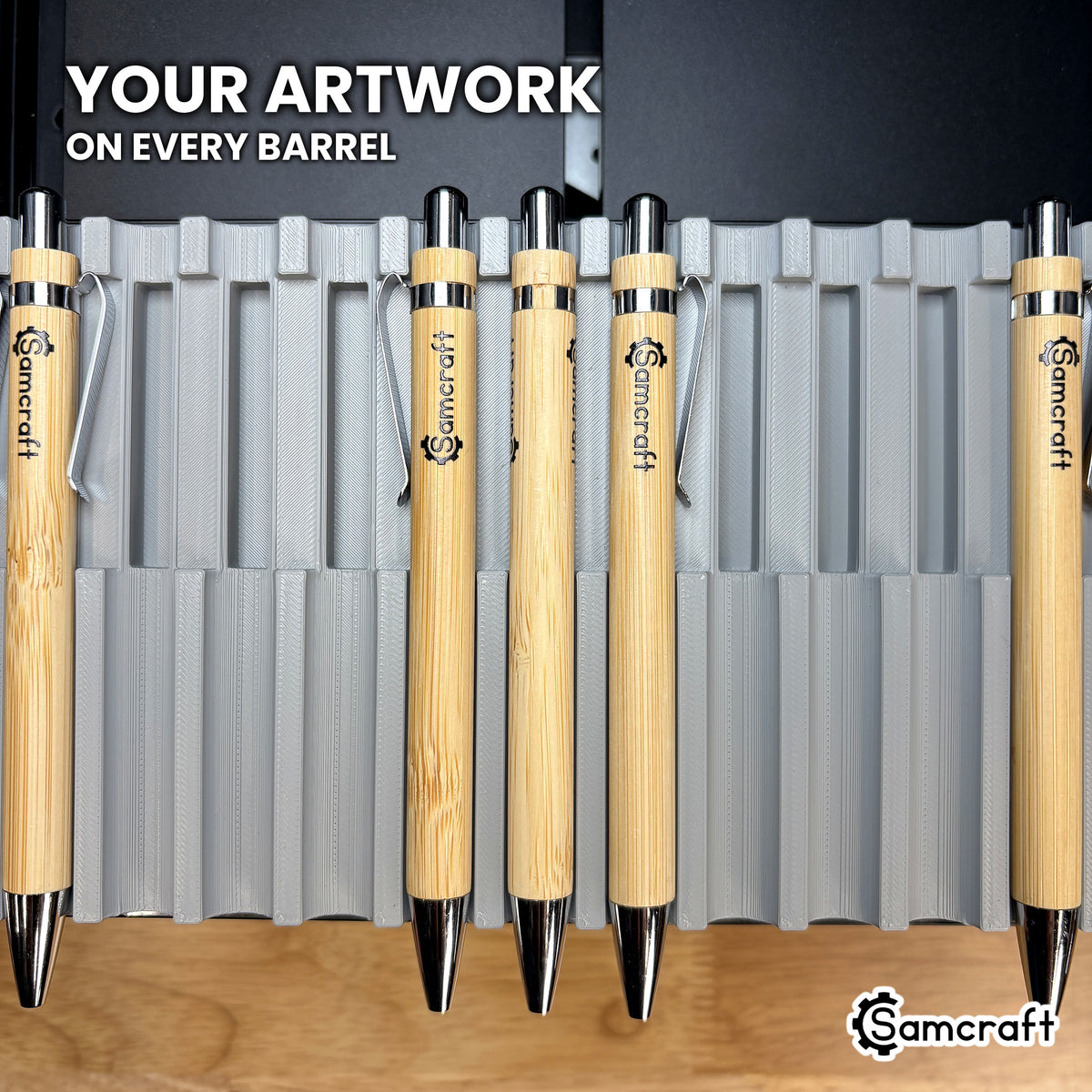 Bamboo ballpoint pens UV printed with the Samcraft logo on the barrel, produced in the Samcraft xTool Omni pen jig.