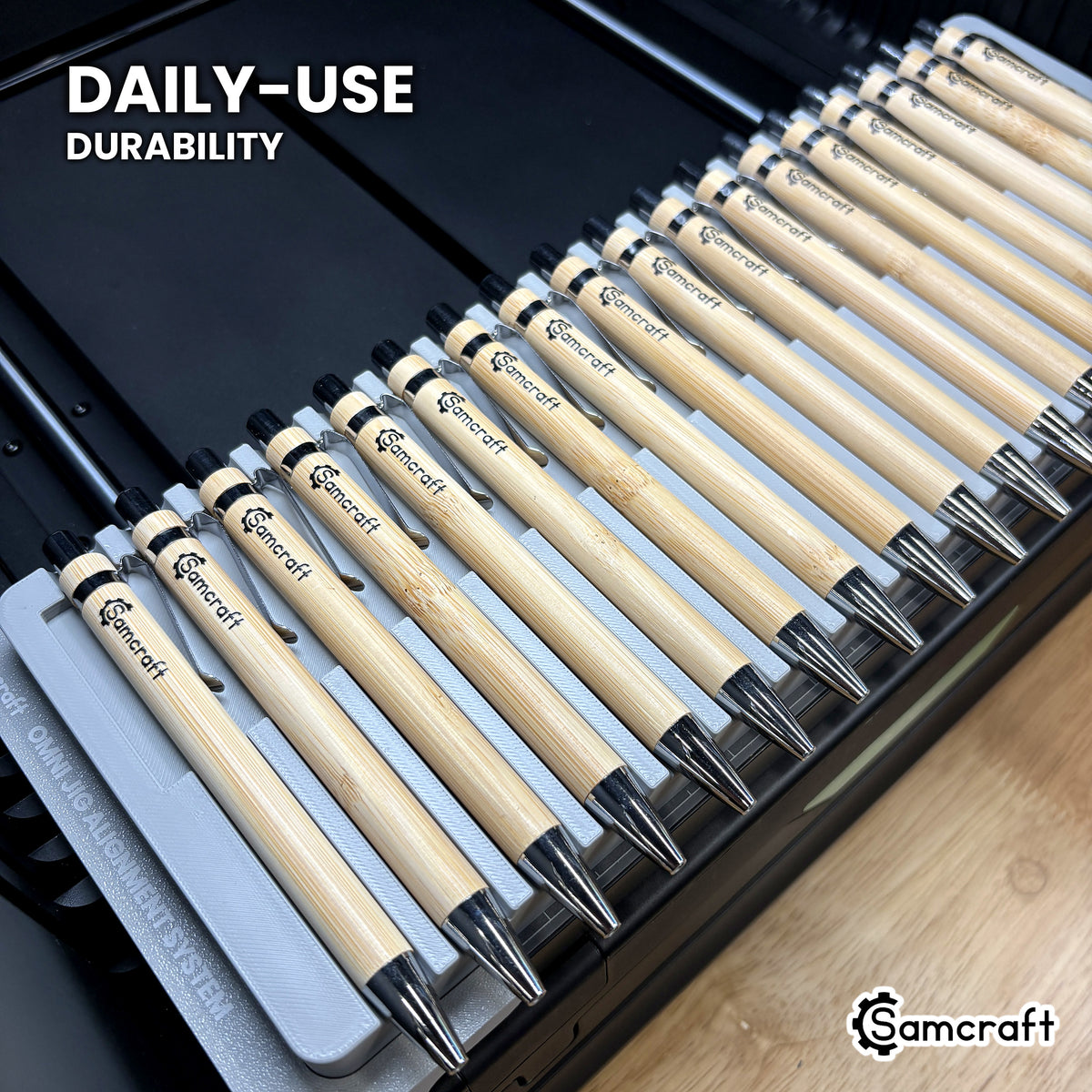 Samcraft pen jig in high-temperature rated plastic holding eighteen bamboo pens on the xTool Omni bed, built for daily-use durability.