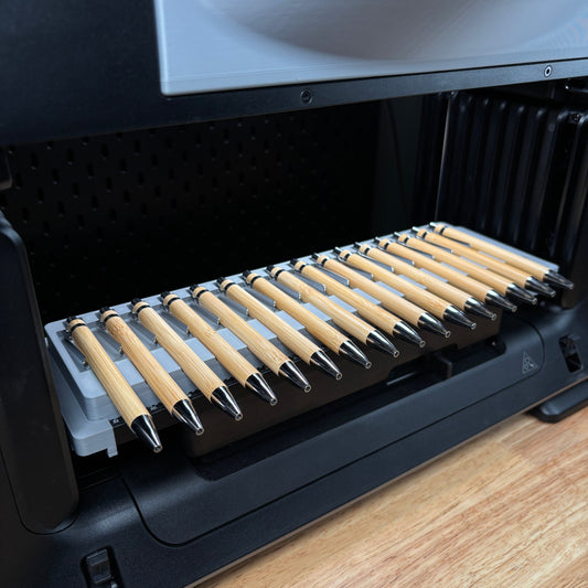 Samcraft 16 piece universal pen jig on the eufyMake E1 print bed, holding sixteen bamboo pens side by side.