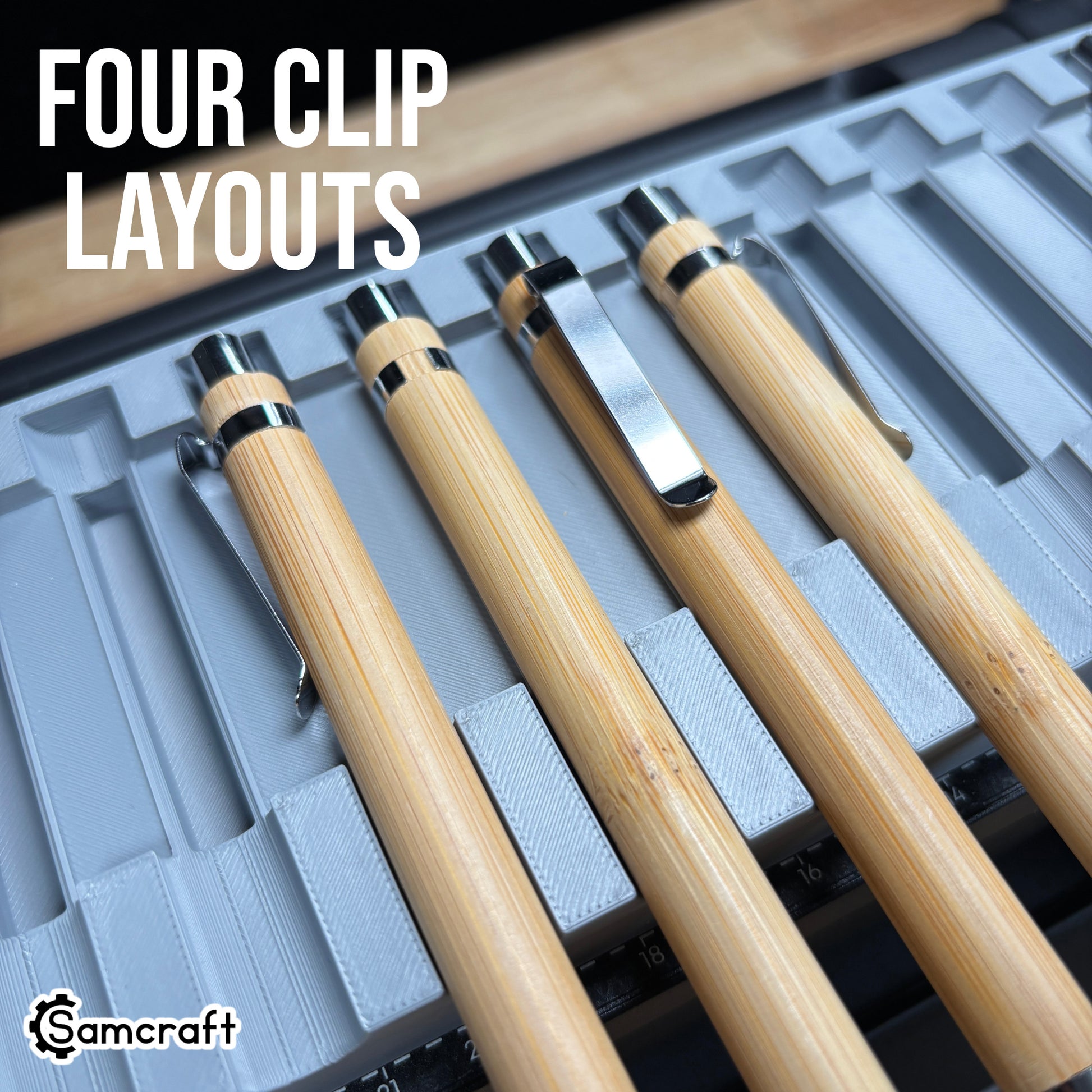 Detail of four bamboo pens showing different chrome clip orientations in the Samcraft Universal Pen Jig's recess relief cutouts on the eufyMake E1.