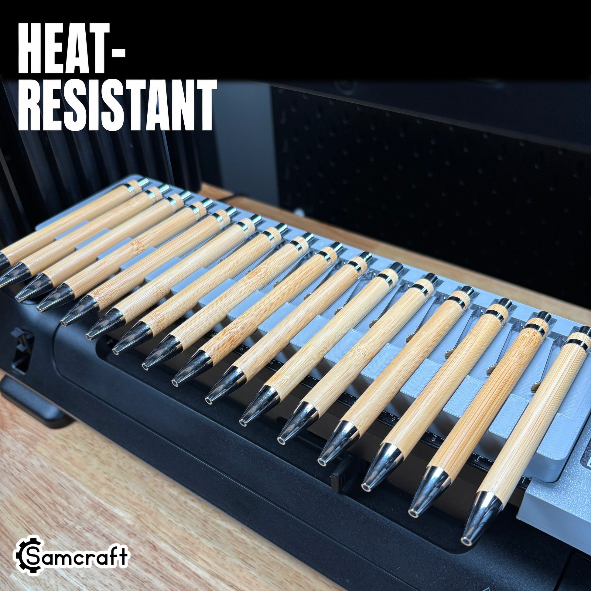 Heat-resistant Samcraft Universal Pen Jig holding sixteen bamboo pens with chrome tips in a gray tray on the eufyMake E1 UV printer.