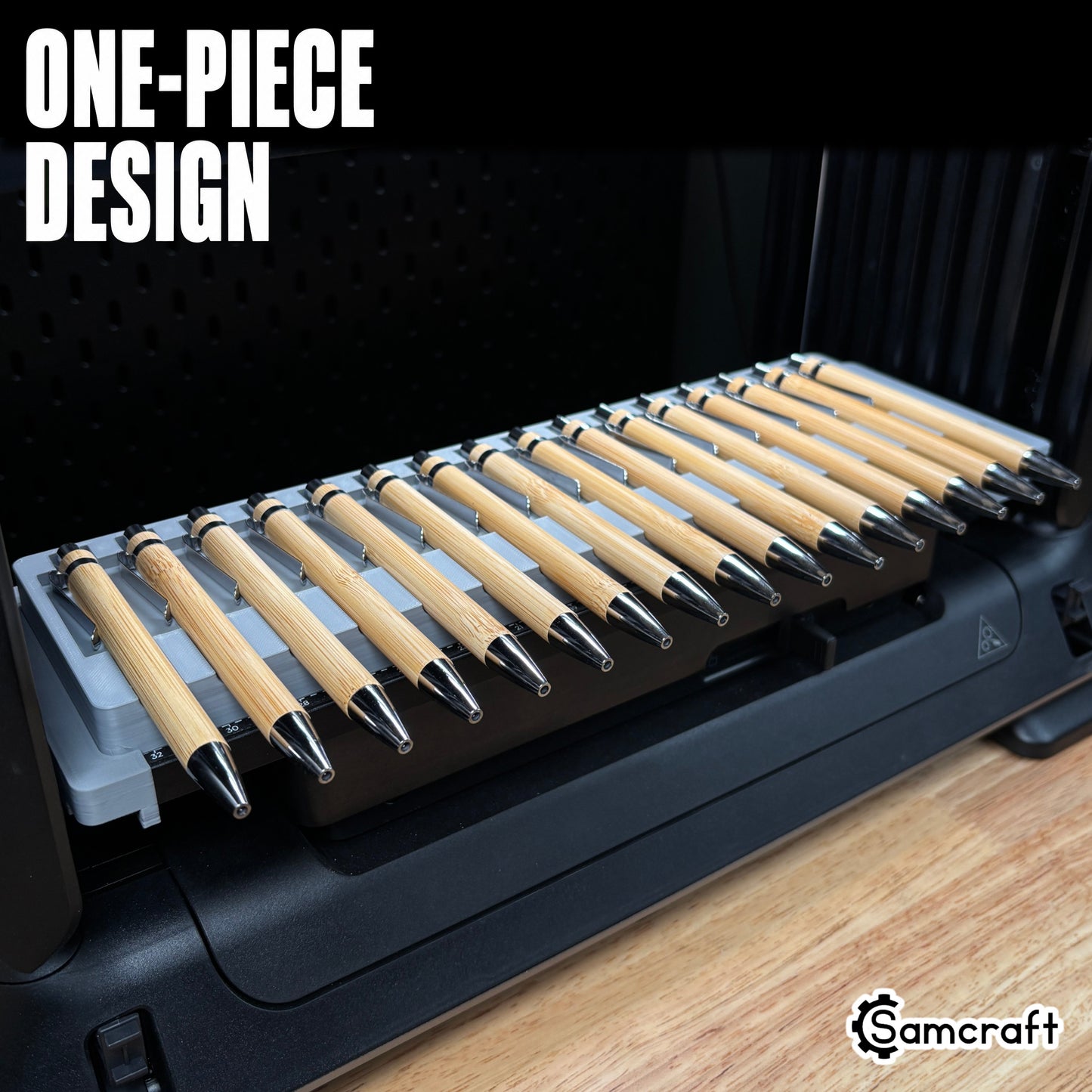 Samcraft Universal Pen Jig holding sixteen bamboo pens with chrome tips in a one-piece gray 3D-printed tray with built-in alignment ruler on the eufyMake E1 UV printer.