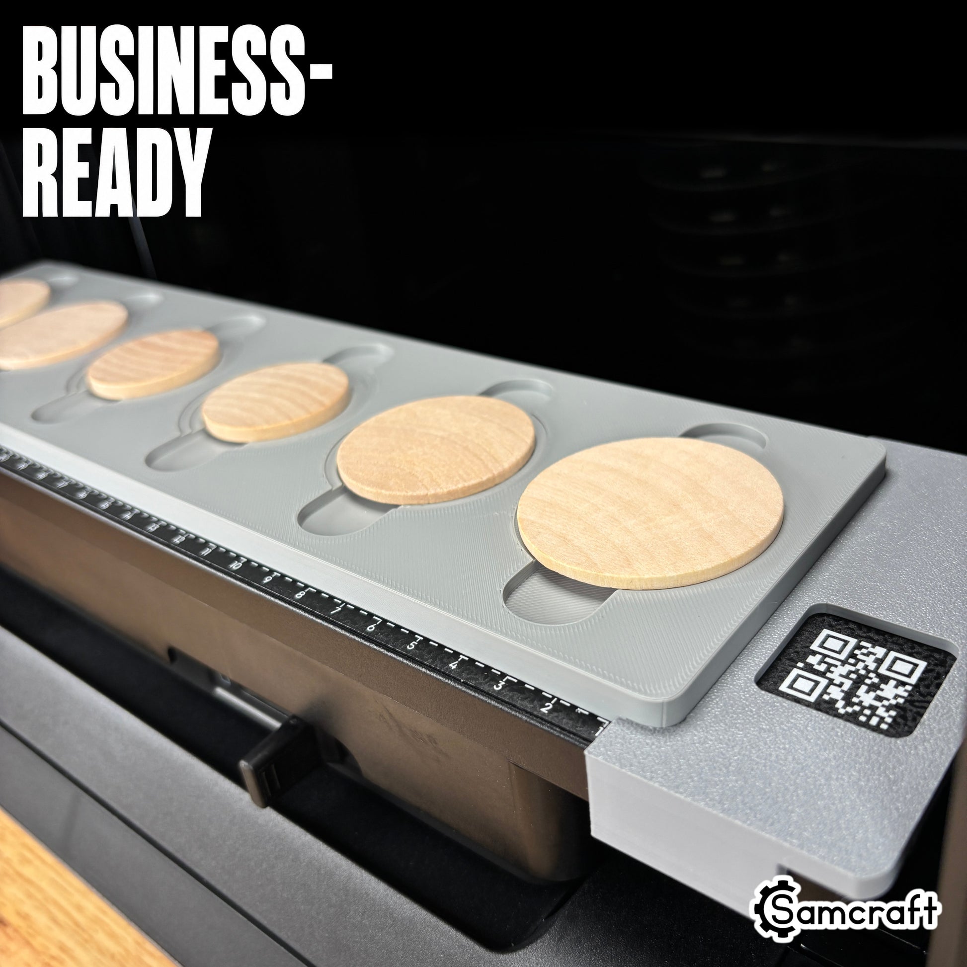 Wood Coin Jig for the eufyMake E1 — close-up of the gray one-piece 3D-printed tray holding round wooden coins on the printer bed with QR code and built-in alignment ruler, highlighting the business-ready design.