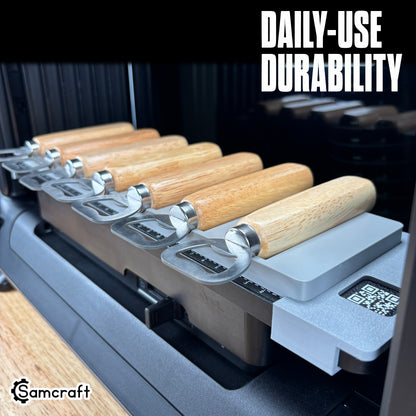 Wood Handle Bottle Opener Jig for the eufyMake E1 — angled view of the gray 3D-printed tray holding a row of wood-handle bottle openers on the printer bed with QR code and built-in alignment ruler, highlighting daily-use durability.