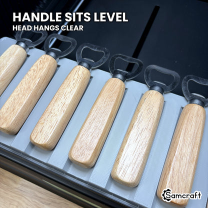 Wood handles sitting level in the Samcraft xTool Omni jig with the steel heads hanging clear of the plate.