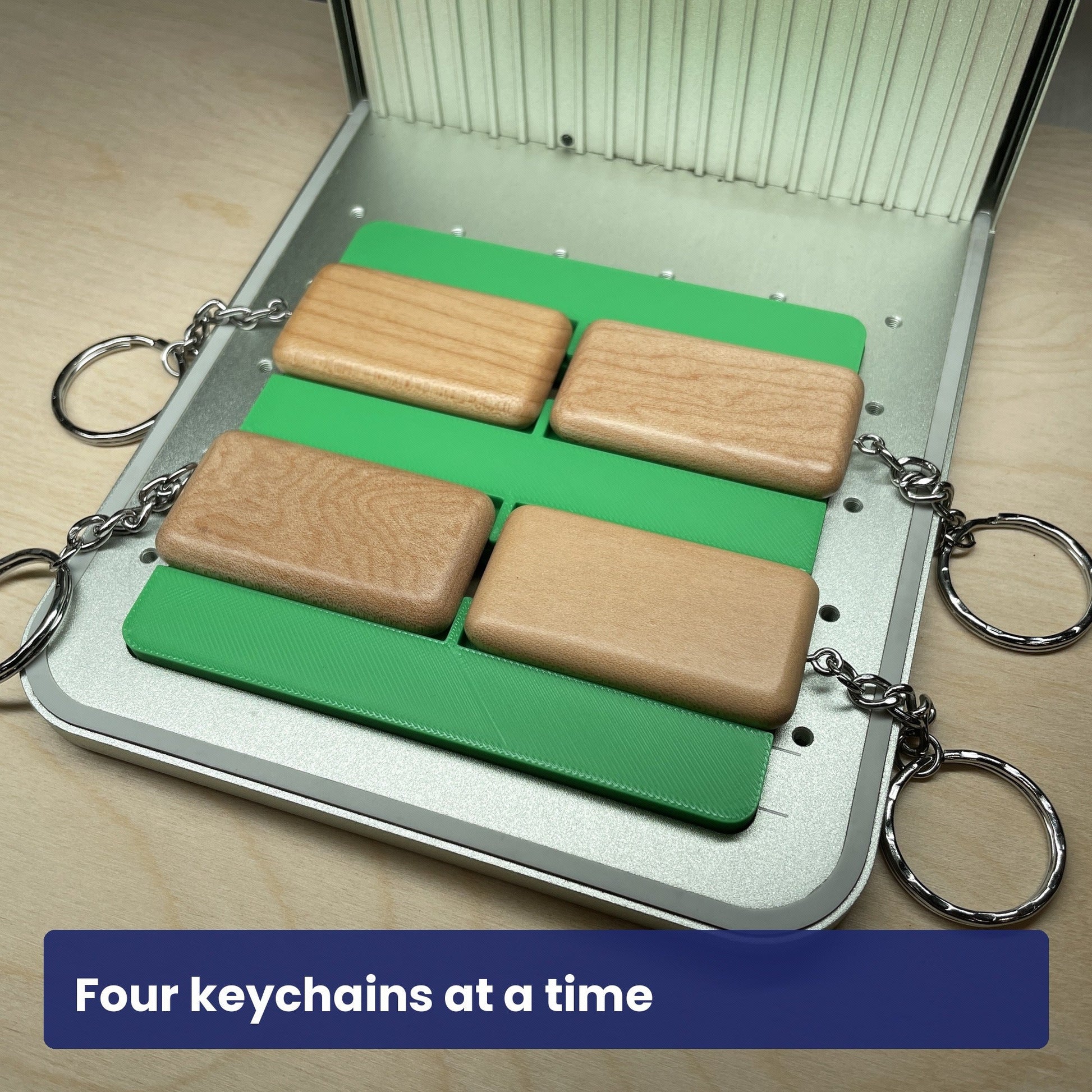 Samcraft keychain jig loaded with four wood rectangle keychains in the laser bed.