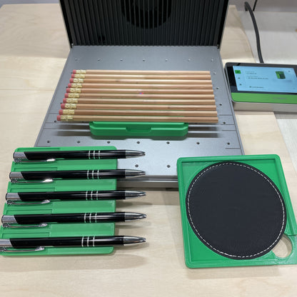 Samcraft xTool F1 jig adapter in an xTool F1 Ultra, letting an F1 jig hold pens, pencils and a leatherette coaster.