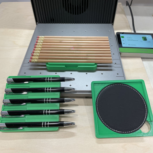 Samcraft xTool F1 jig adapter in an xTool F1 Ultra, letting an F1 jig hold pens, pencils and a leatherette coaster.